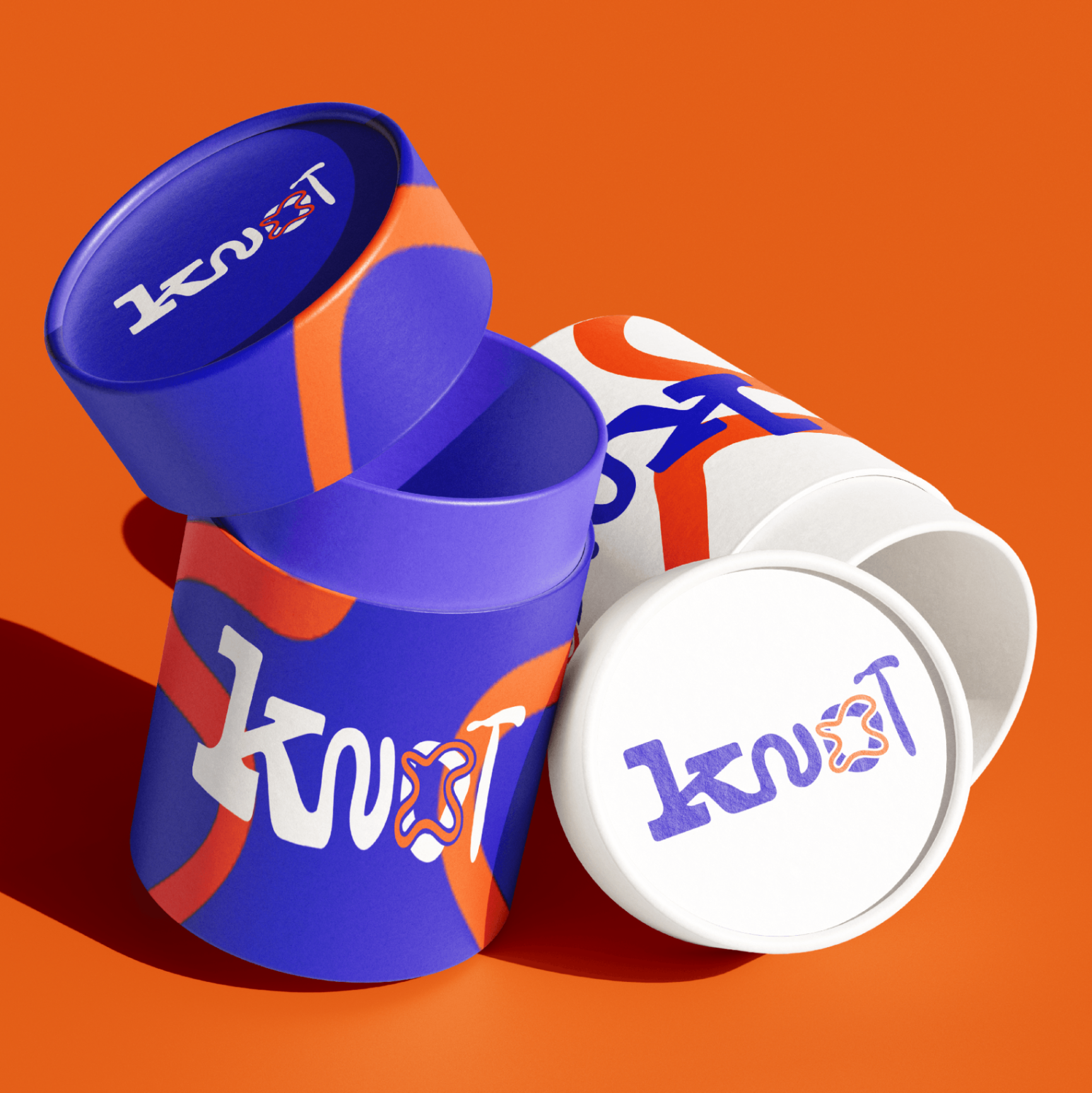 Knot packaging — cylindrical boxes with blue and orange artwork